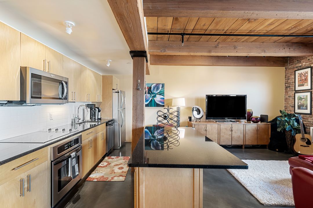 modern kitchen with breakfast bar and stainless steel appliances