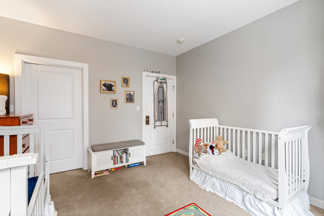 small beige bedroom with carpet floors