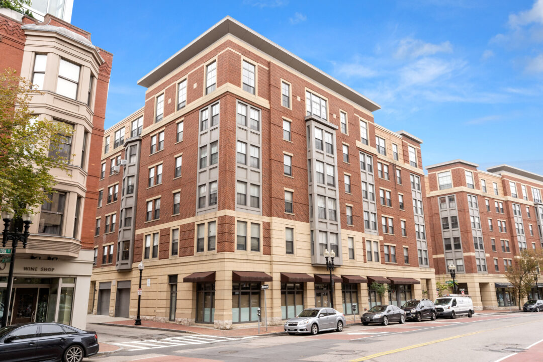 multi-story apartment building with brick exterior and large windows