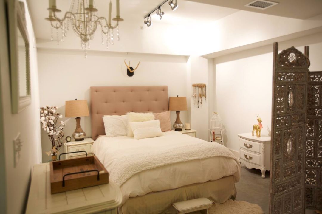 small beige bedroom with natural light and wood floors
