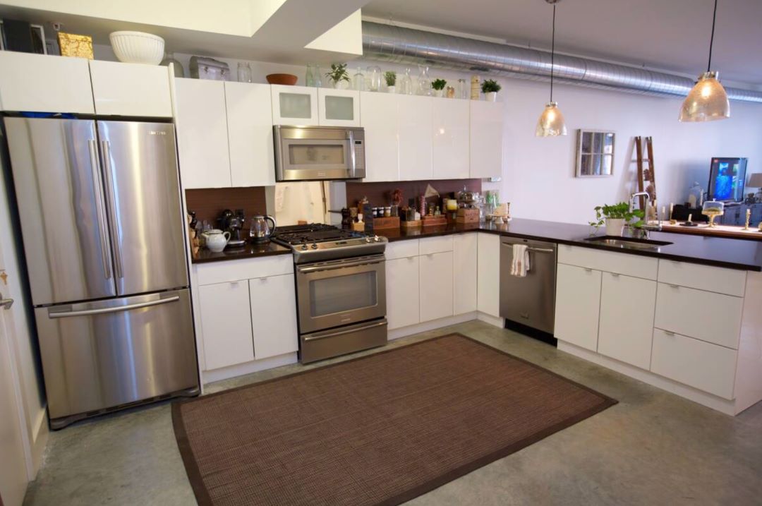 updated kitchen with white cabinets and stainless appliances