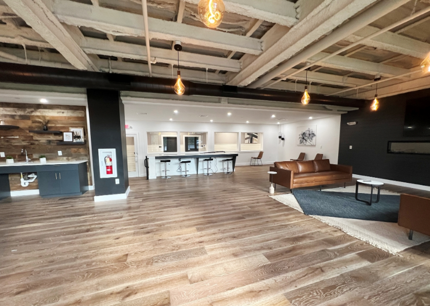 Common room with bar, seating areas, TV, and fireplace