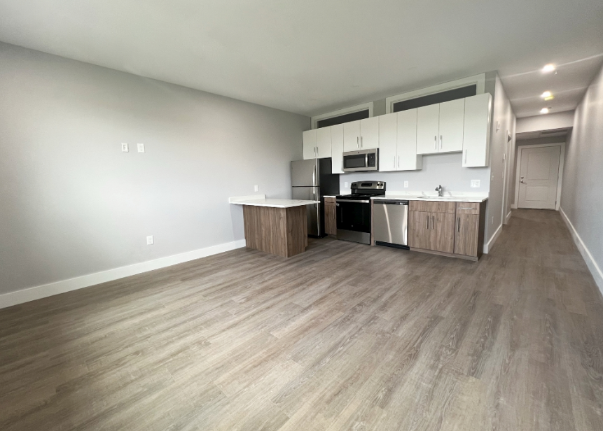 Open floor plan kitchen with refrigerator, dishwasher, and microwave