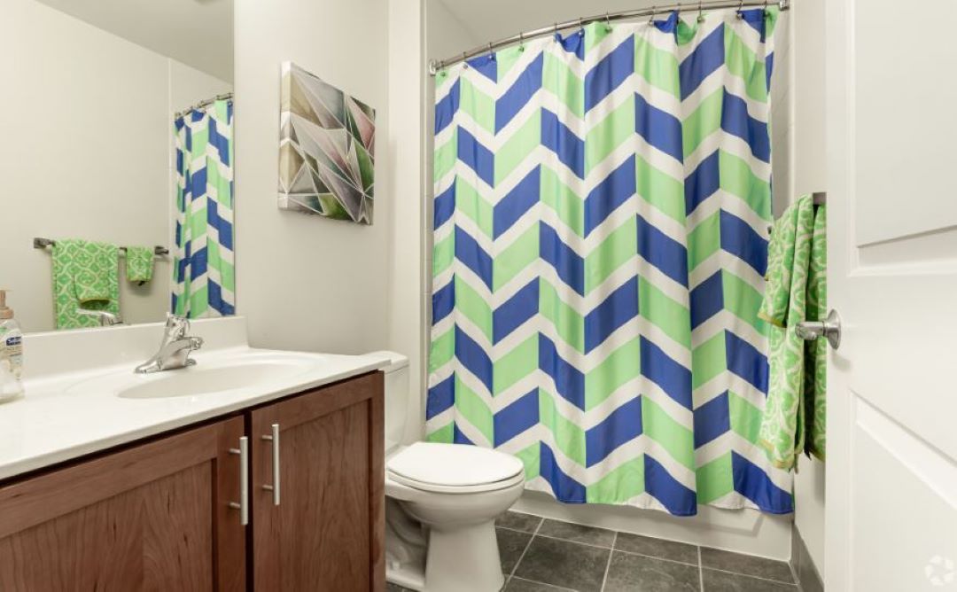 modern bathroom with full tub and tile flooring