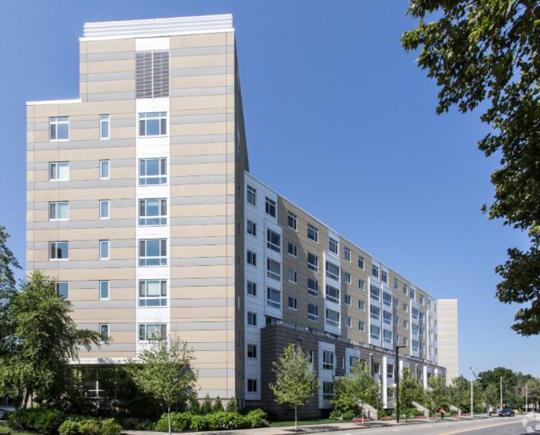 multi-story apartment building with brick exterior and large windows