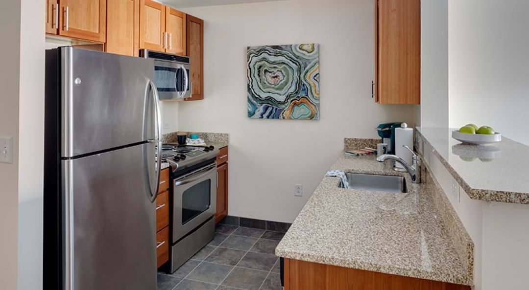 modern kitchen with tile floor and stainless steel appliances