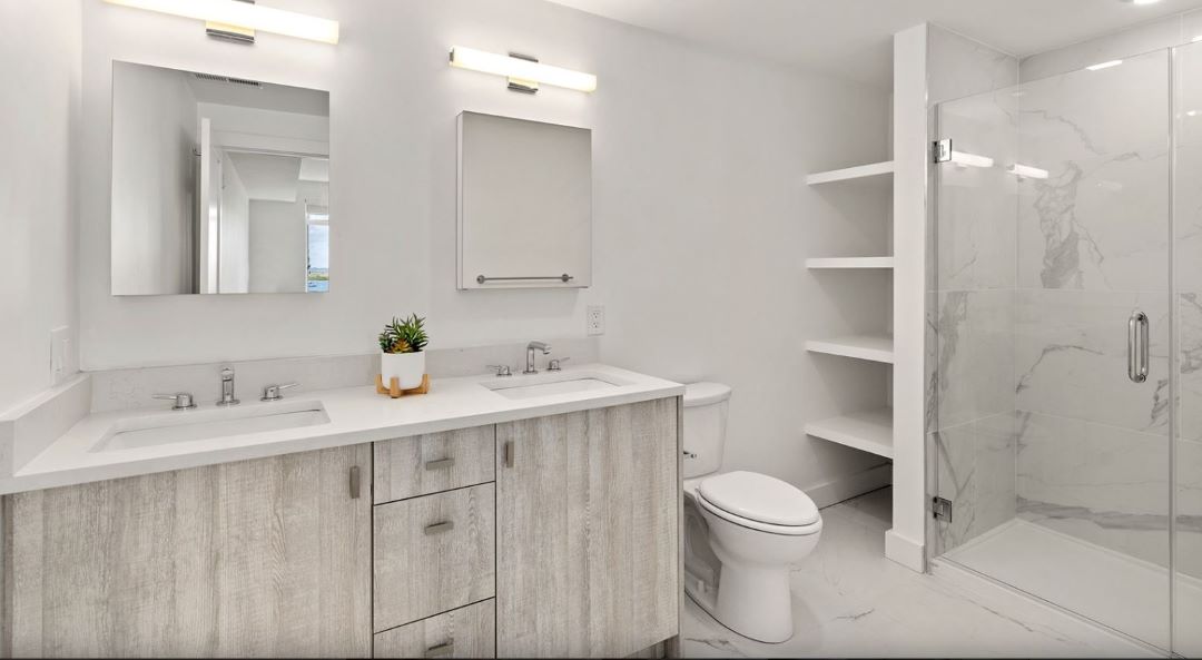 modern bathroom with dual sinks, and glass shower