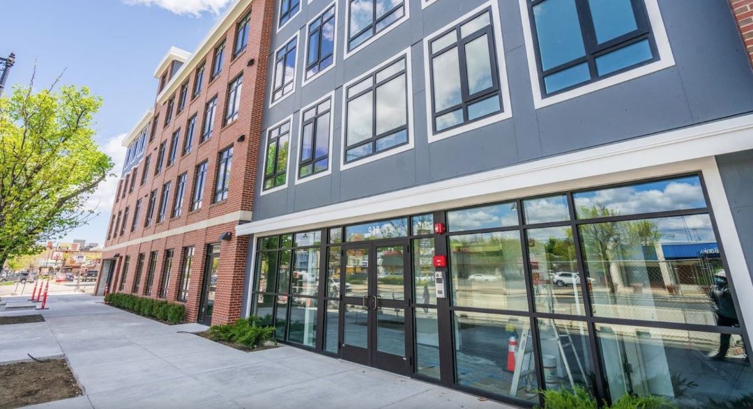 multi-story apartment building with brick exterior and large windows