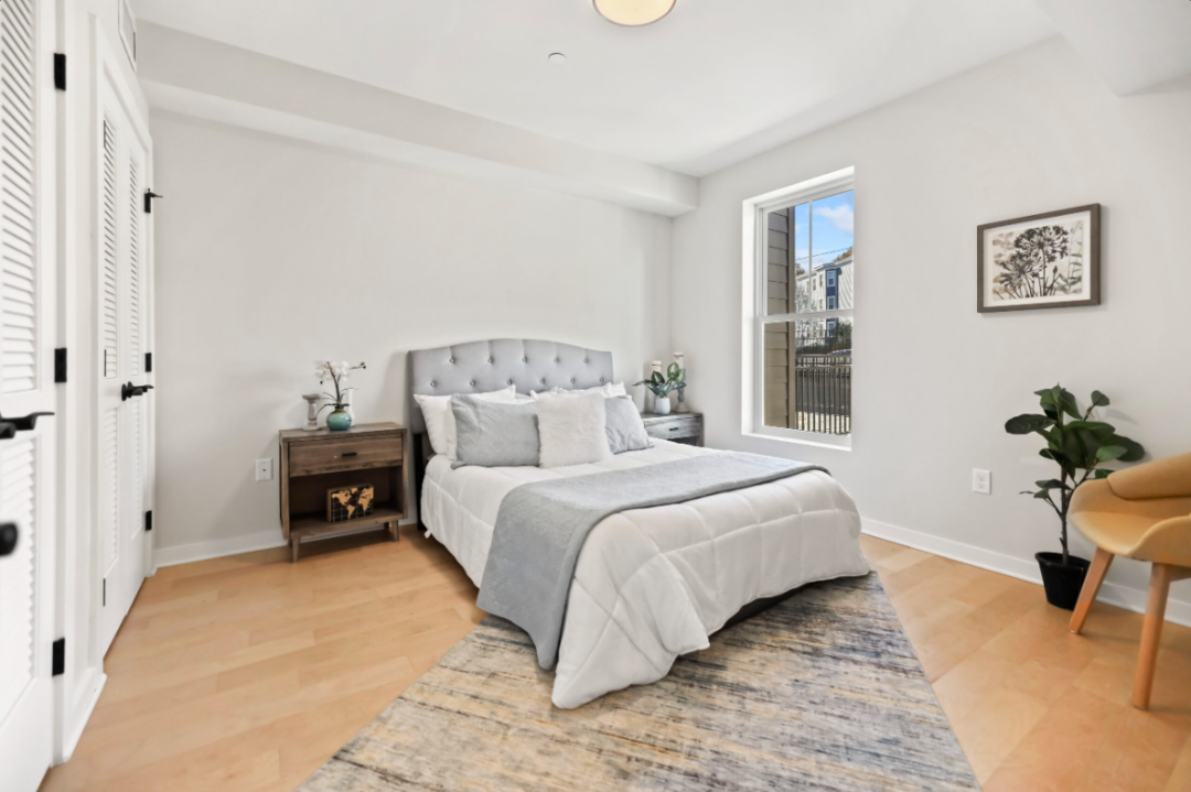 Bedroom with hardwood floors and natural light