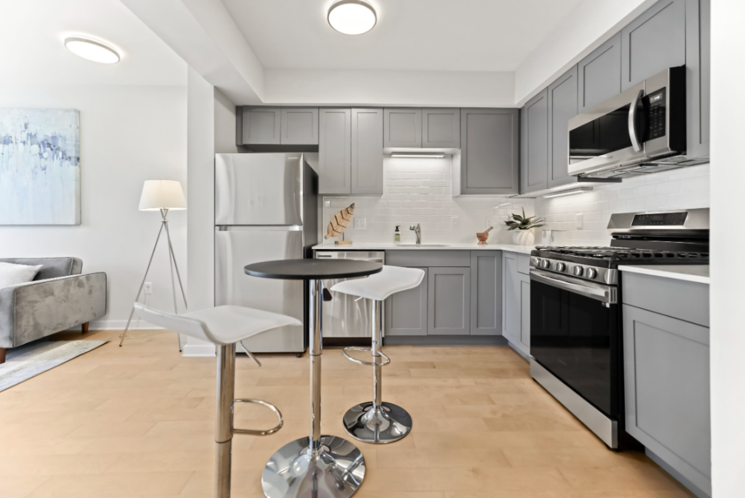 Kitchen with refrigerator, dishwasher, stove/oven, and hardwood floors