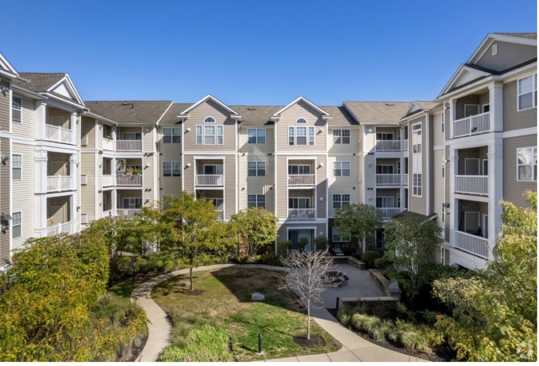 multi-story apartment building with windows and balconies