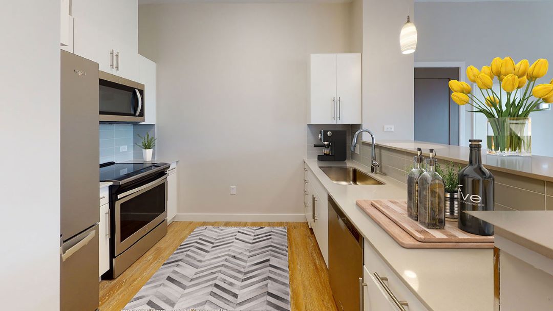 modern kitchen with white cabinets, stainless steel appliances and hardwood floors