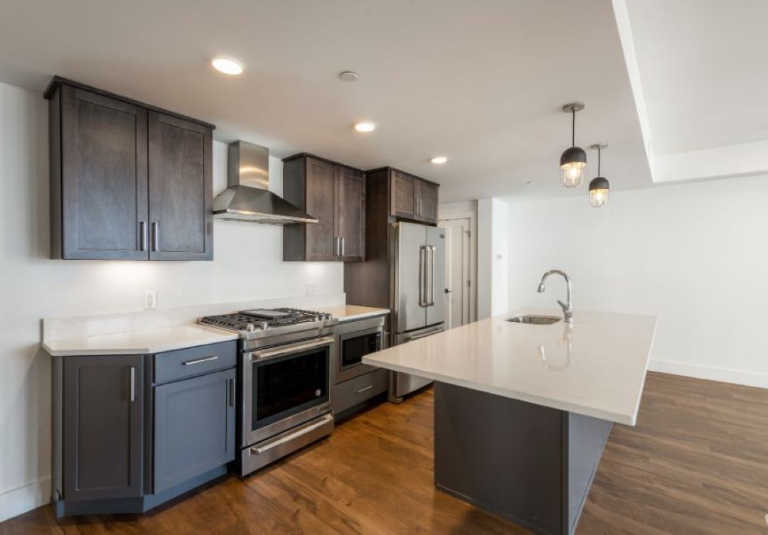 modern kitchen with stainless appliances and hardwood floors