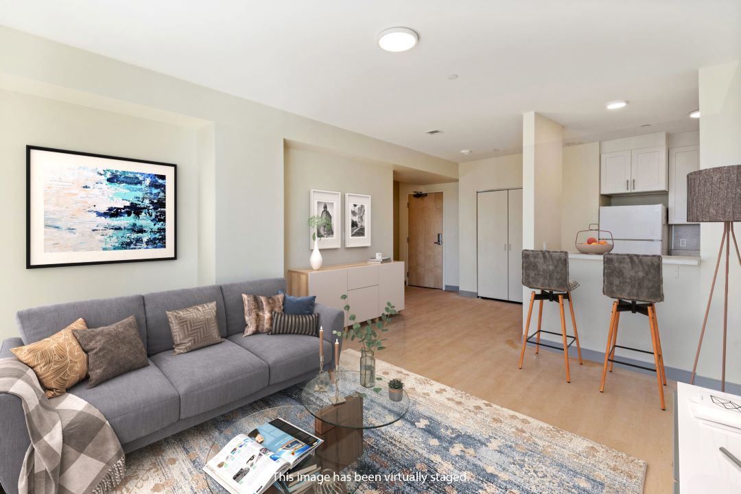 open floor plan kitchen living room combo with hardwood floors, beige walls and natural light