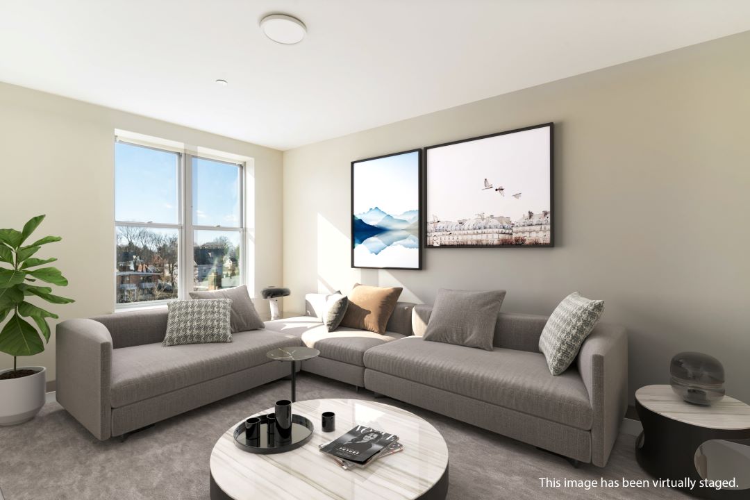 living room with beige walls large window and natural light