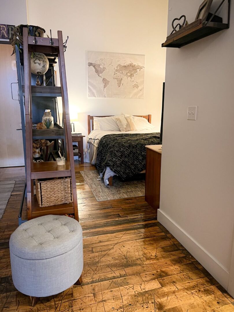 main bedroom with wood floors and beige walls