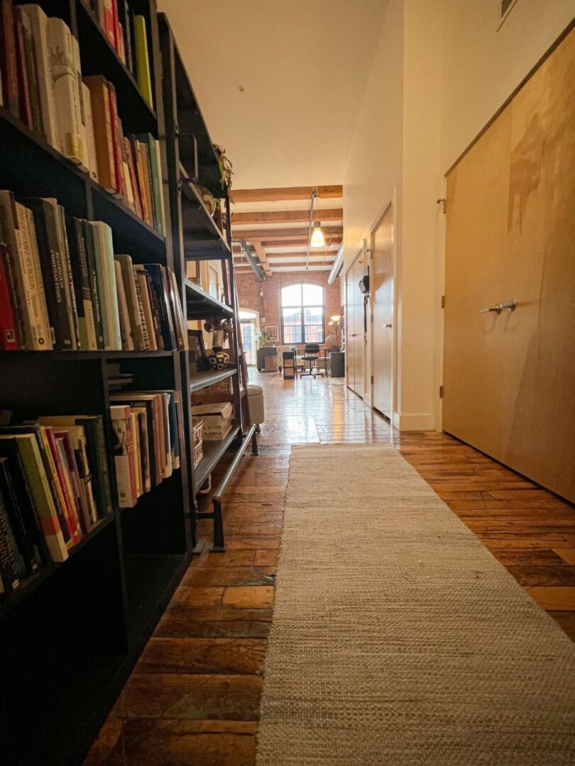 entry way with high ceilings, wood floors and beige walls