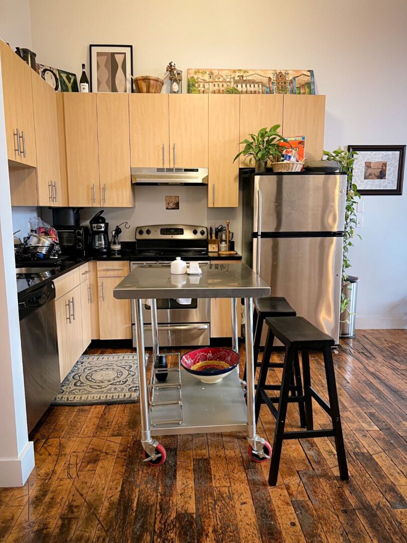 modern kitchen with wood floors, and stainless steel appliances