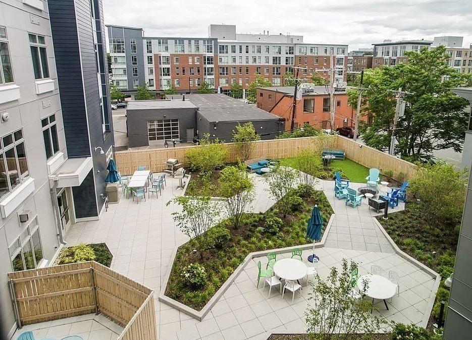 outdoor exterior patio area of 180 Telford with tables and umbrellas and greenery
