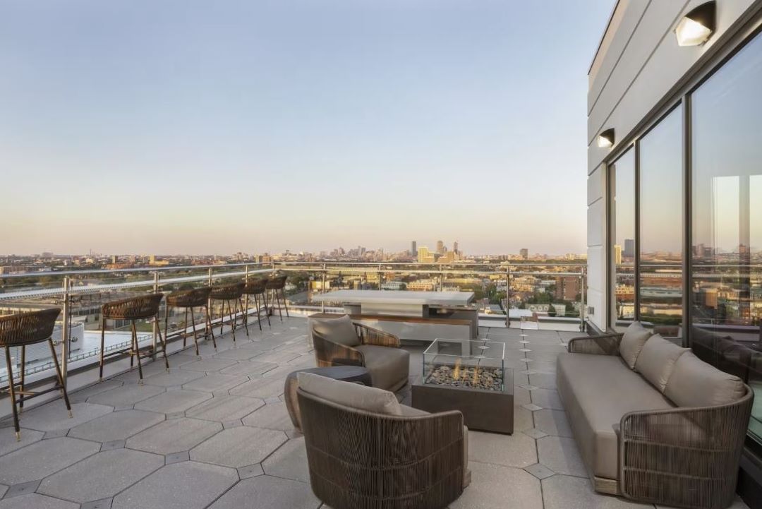 outdoor lounge area with firepits and skyline views