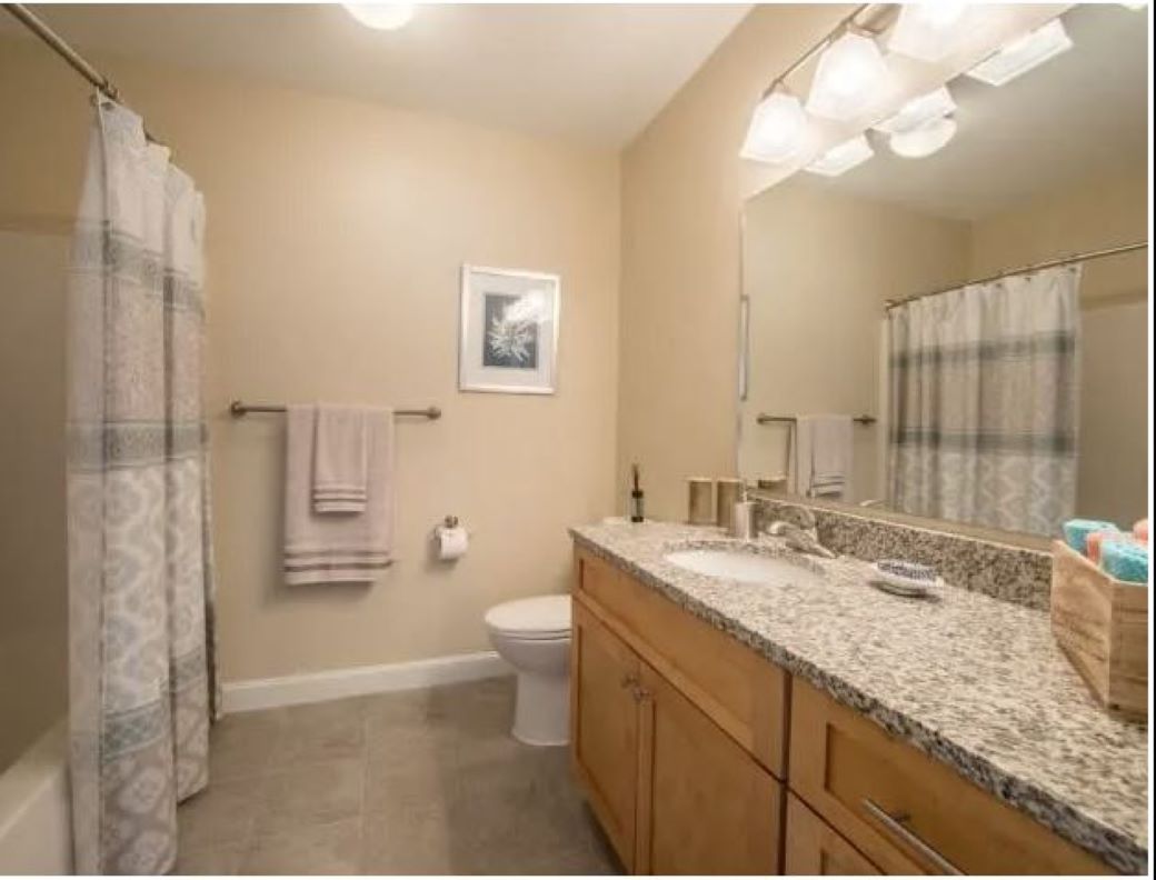 updated bathroom with vanity and shower