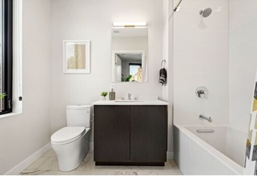 modern bathroom, with tile floors, vanity and shower/tub combo