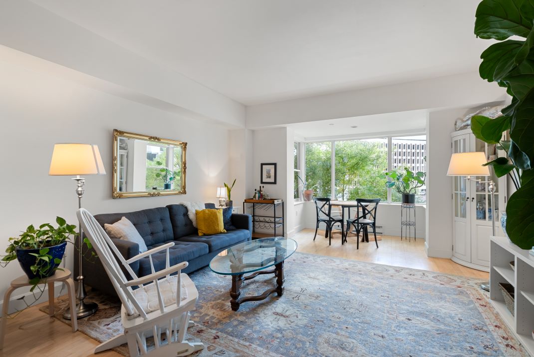 open concept living room with hardwood floors and natural sunlight