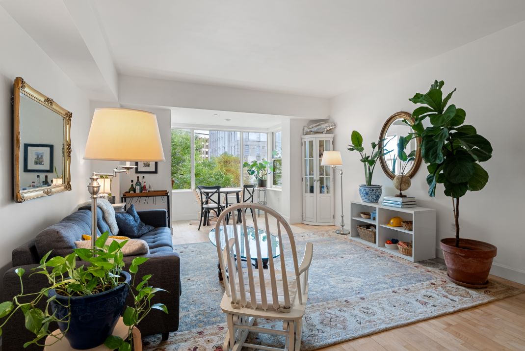 open concept living room with hardwood floors and natural sunlight