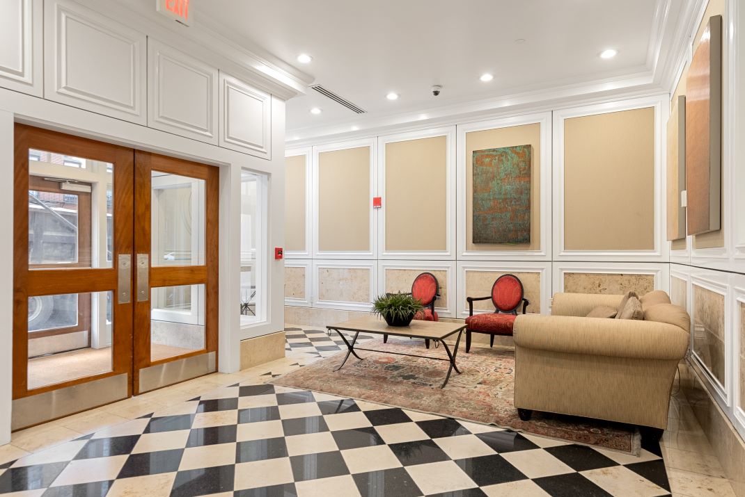 lobby area with chairs, couch and tile floor