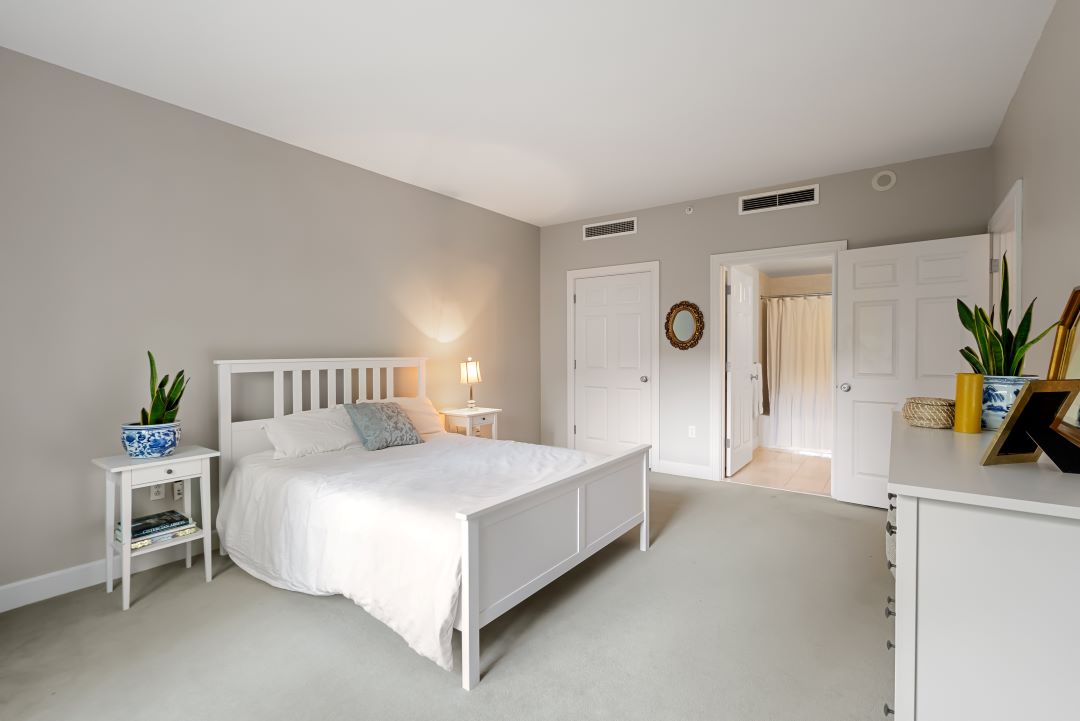 master bedroom with beige carpets and natural light