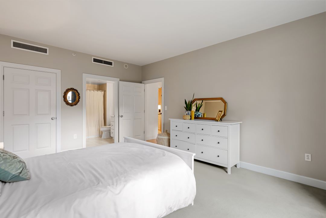 master bedroom with beige carpets and natural light