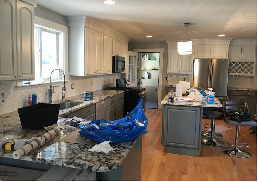 modern kitchen with white cabinets, hardwood floor and granite counters