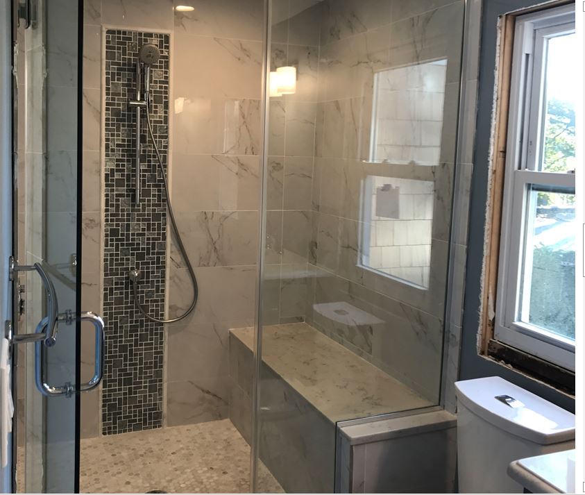 updated bathroom with tile and glass shower