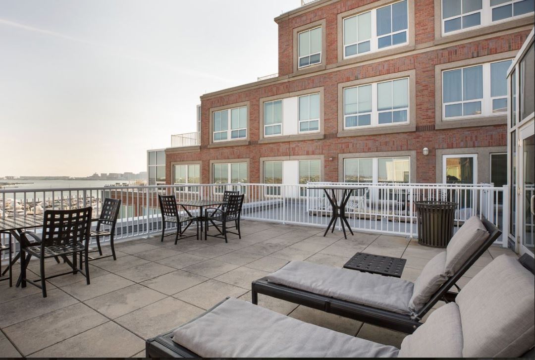 rooftop terrace with tables, chairs and loungers