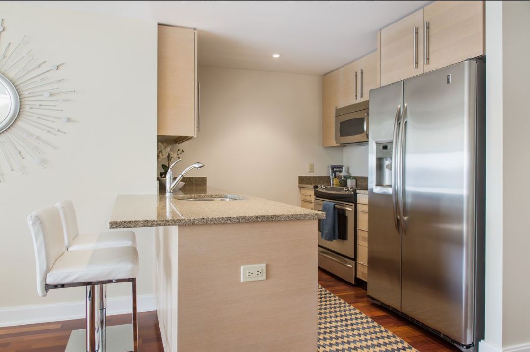 modern kitchen with stainless steel appliances and hardwood floors