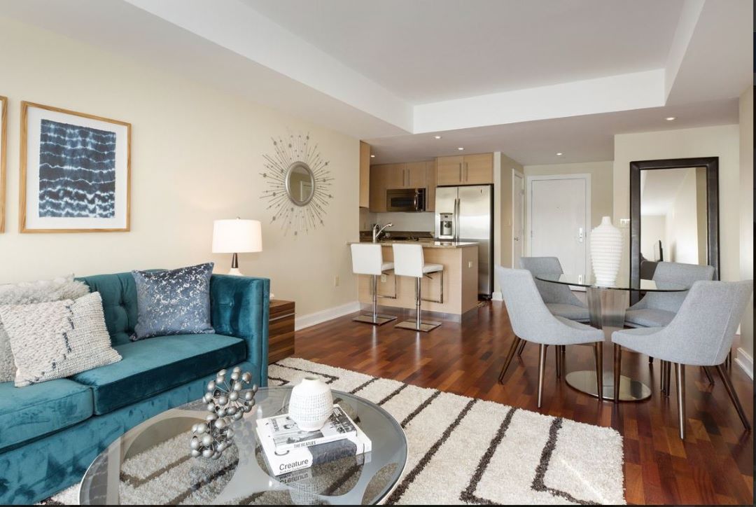 open concept kitchen and living room with hardwood floors and picture window