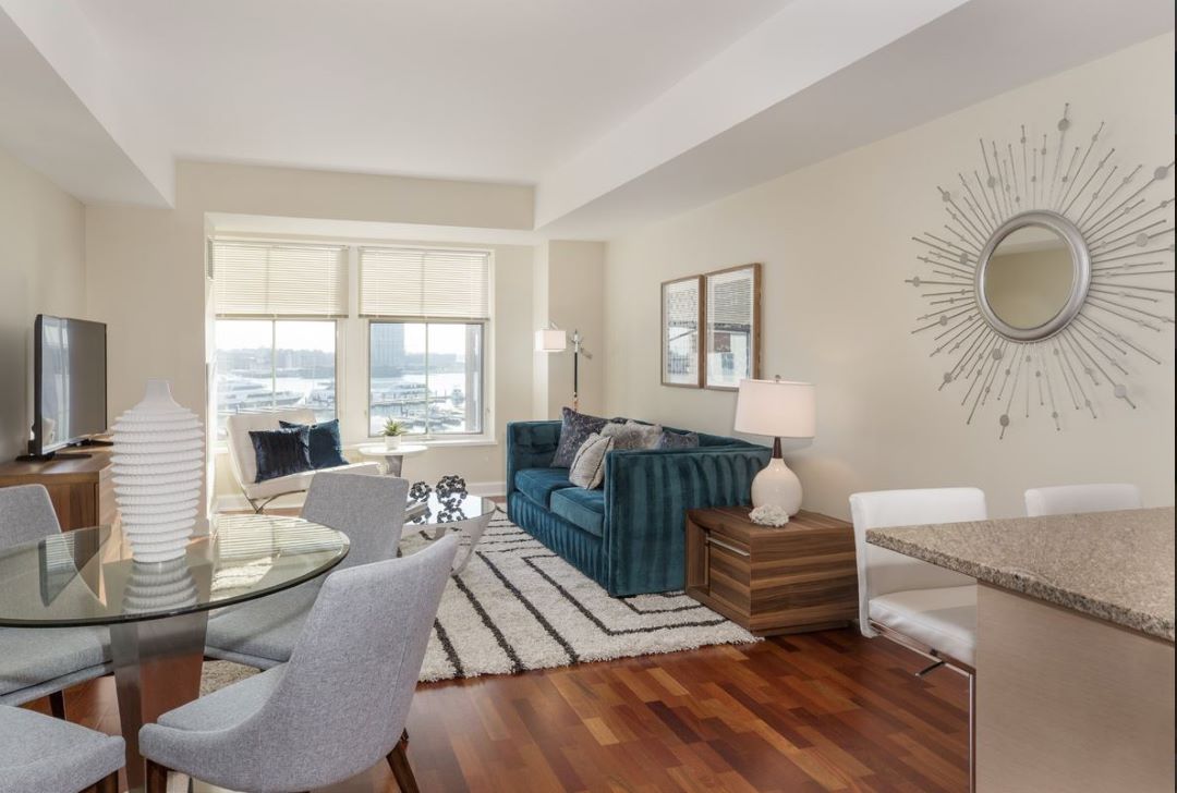 open concept kitchen and living room with hardwood floors and picture window