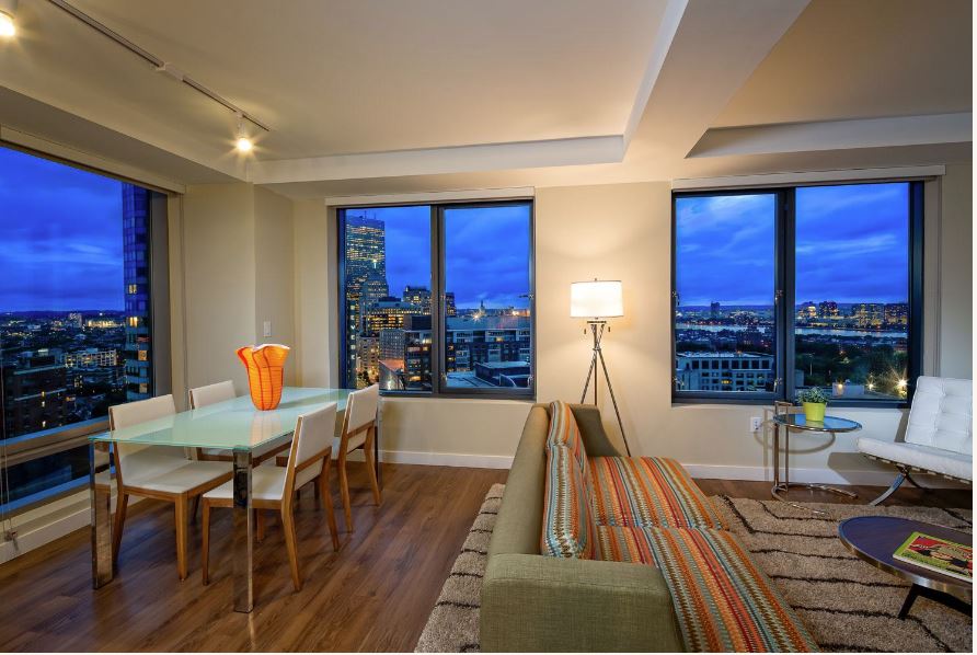 Modern living area with large windows and wood floors