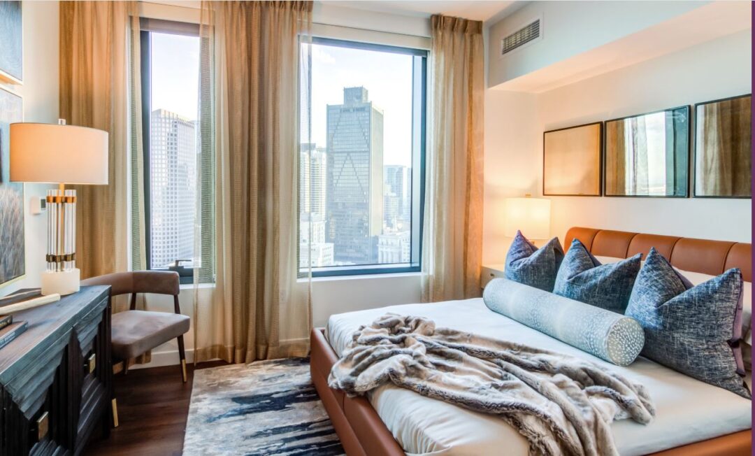 small bedroom with picture window and hardwood floors