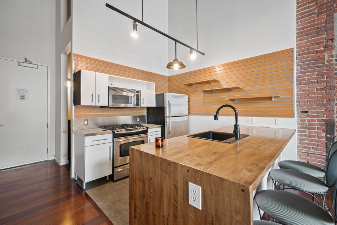 modern style kitchen with stainless steel appliances and center countertop