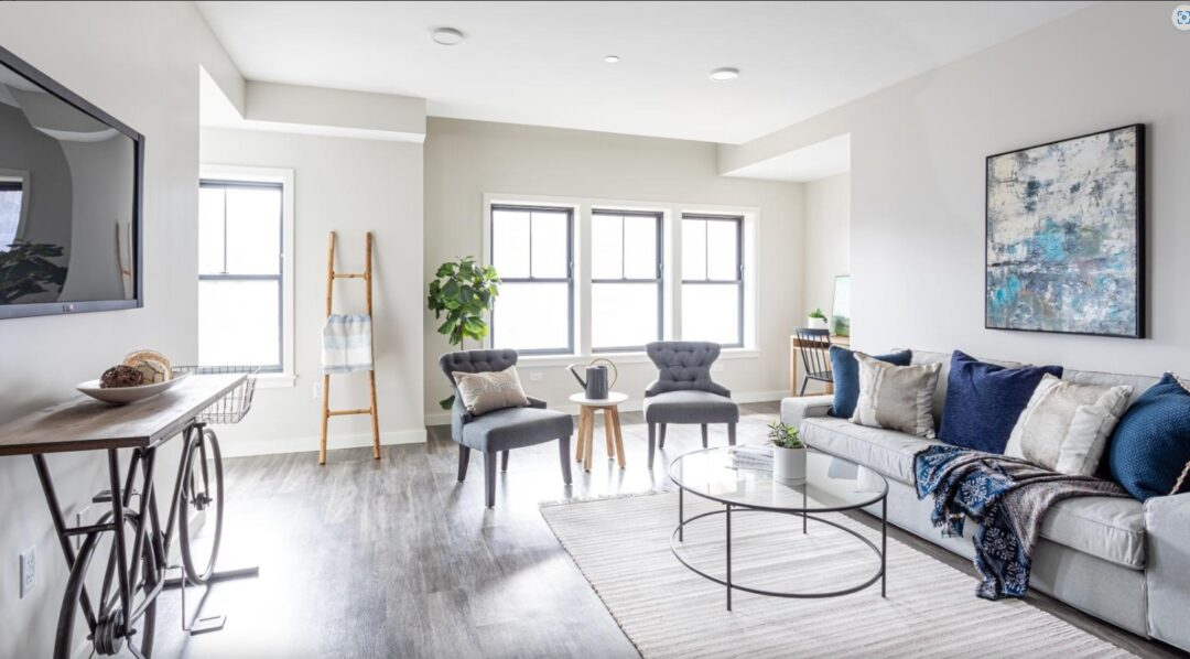 updated living room with wood floors , windows and natural light