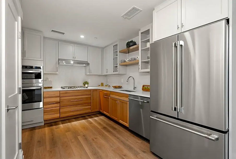 modern kitchen with wood floors and updated cabinets