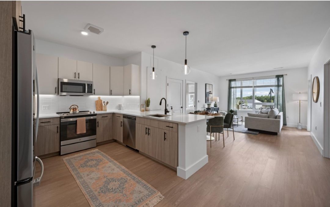 modern kitchen with stainless steel appliances and wood floors