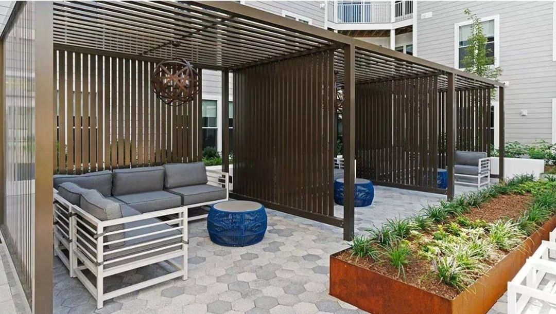 outdoor cabana area on patio with couch and table