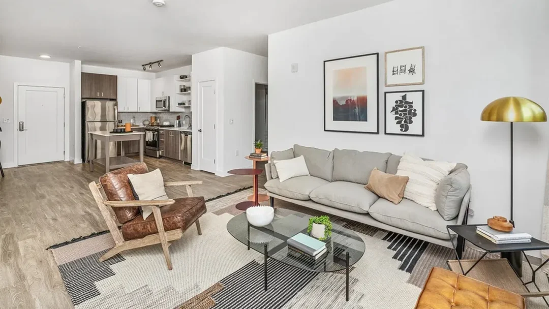 modern living room with beige walls, wood floors and natural light