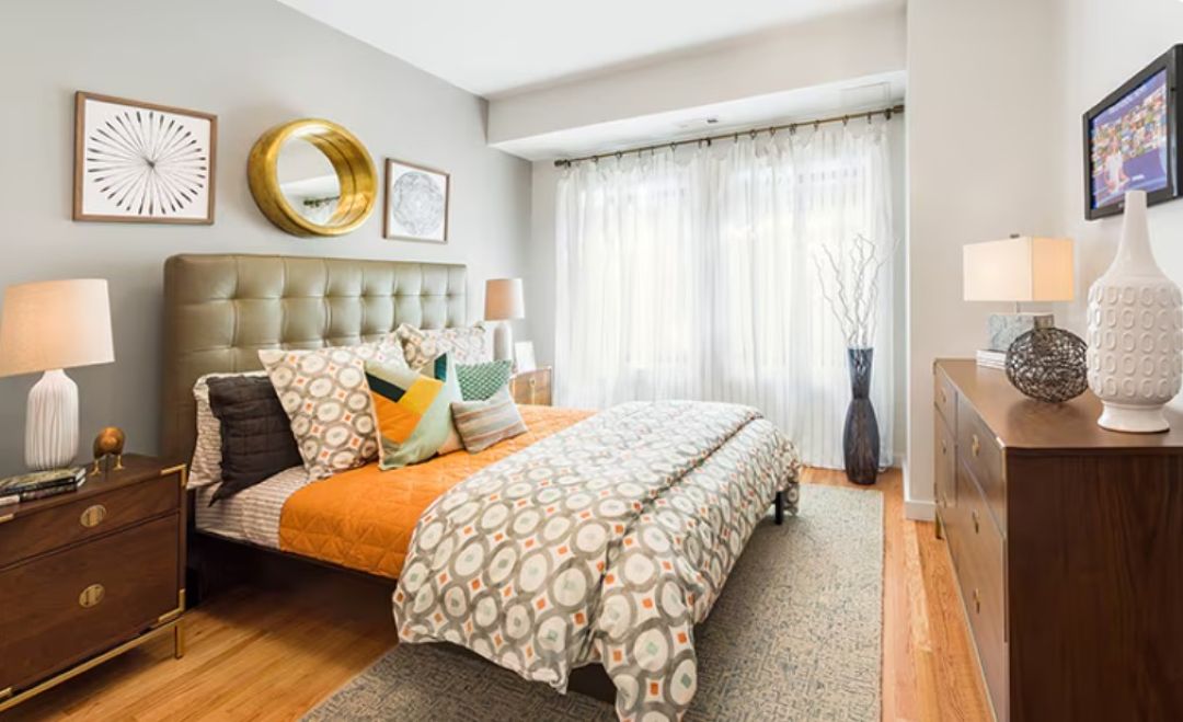 small bedroom with wood floors and natural light