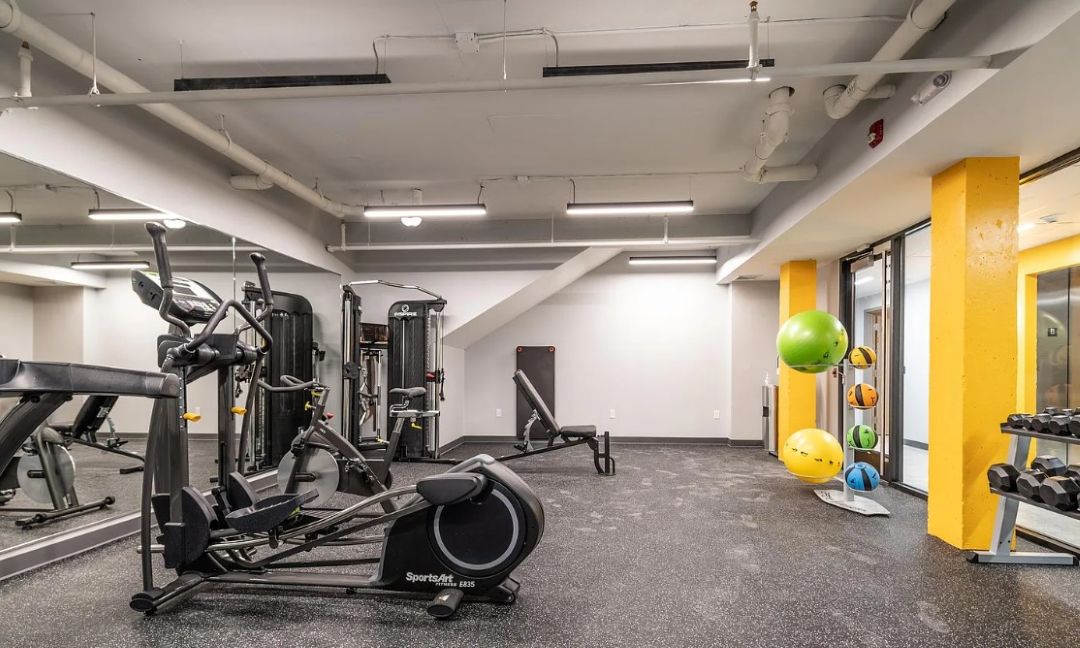fitness center with an assortment of exercise machines and weights