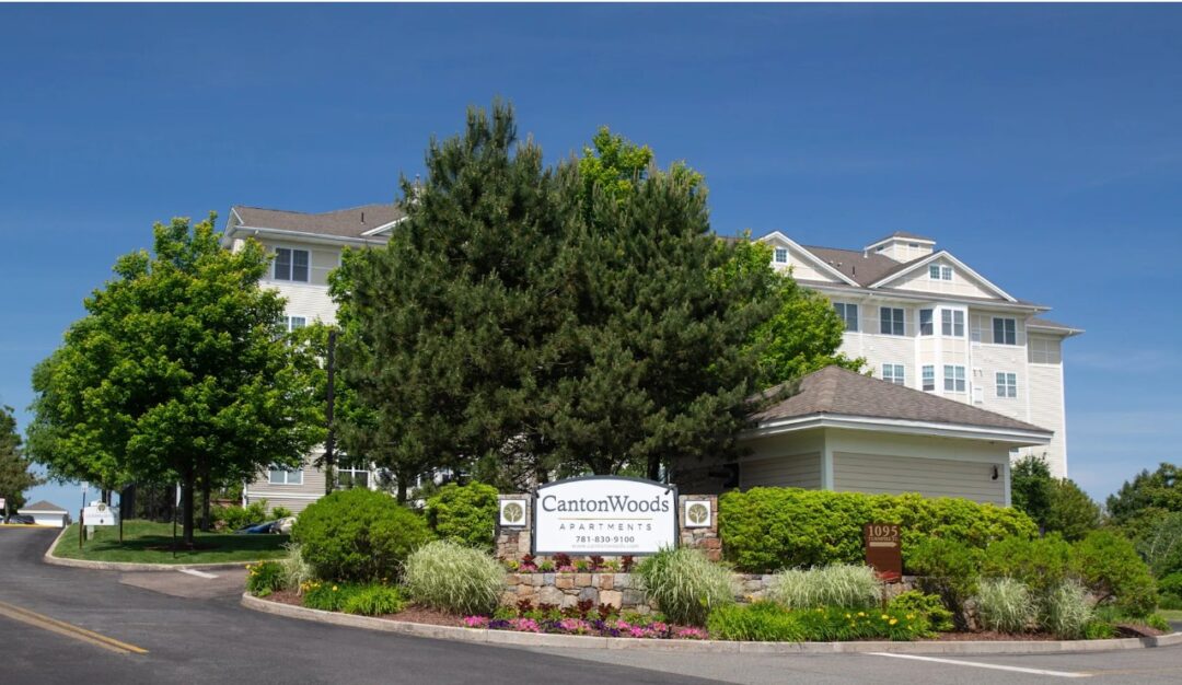 Large apartment complex featuring multiple buildings garden/street view