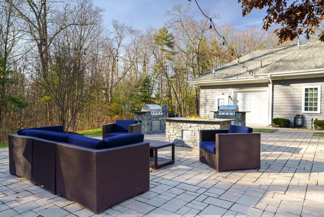 outdoor patio area with chairs and grills