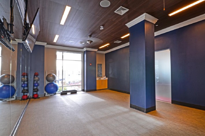 state of the art fitness center with high ceilings and equipment